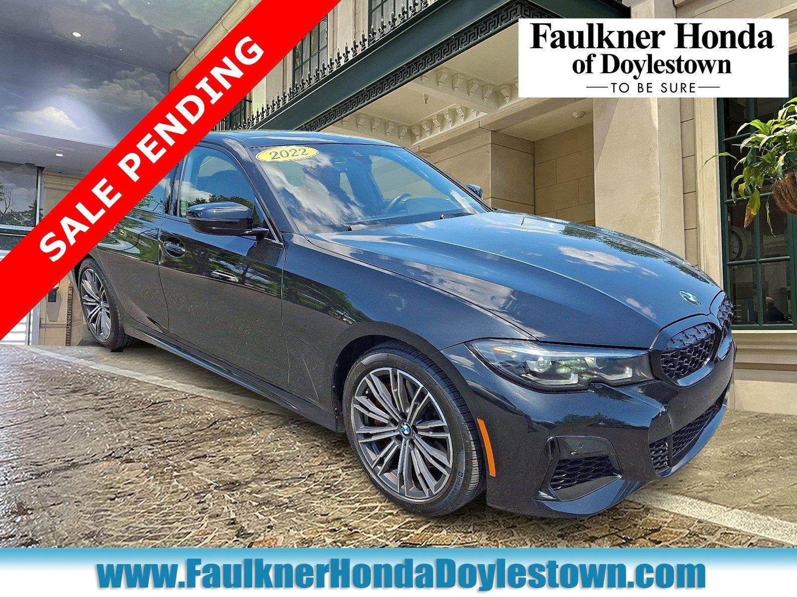 2022 BMW M340i xDrive Sedan North America in Black Sapphire Metallic — front three-quarter view