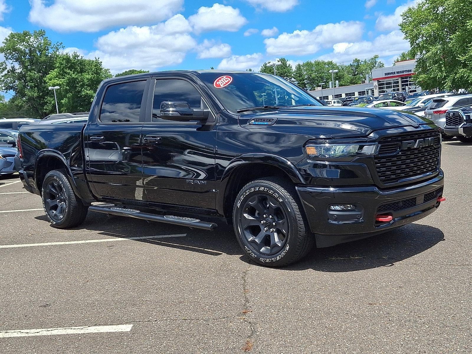 2025 RAM 1500 Big Horn 4x4 Crew Cab 5'7" Box in Diamond Black Crystal Pearlcoat — front three-quarter view