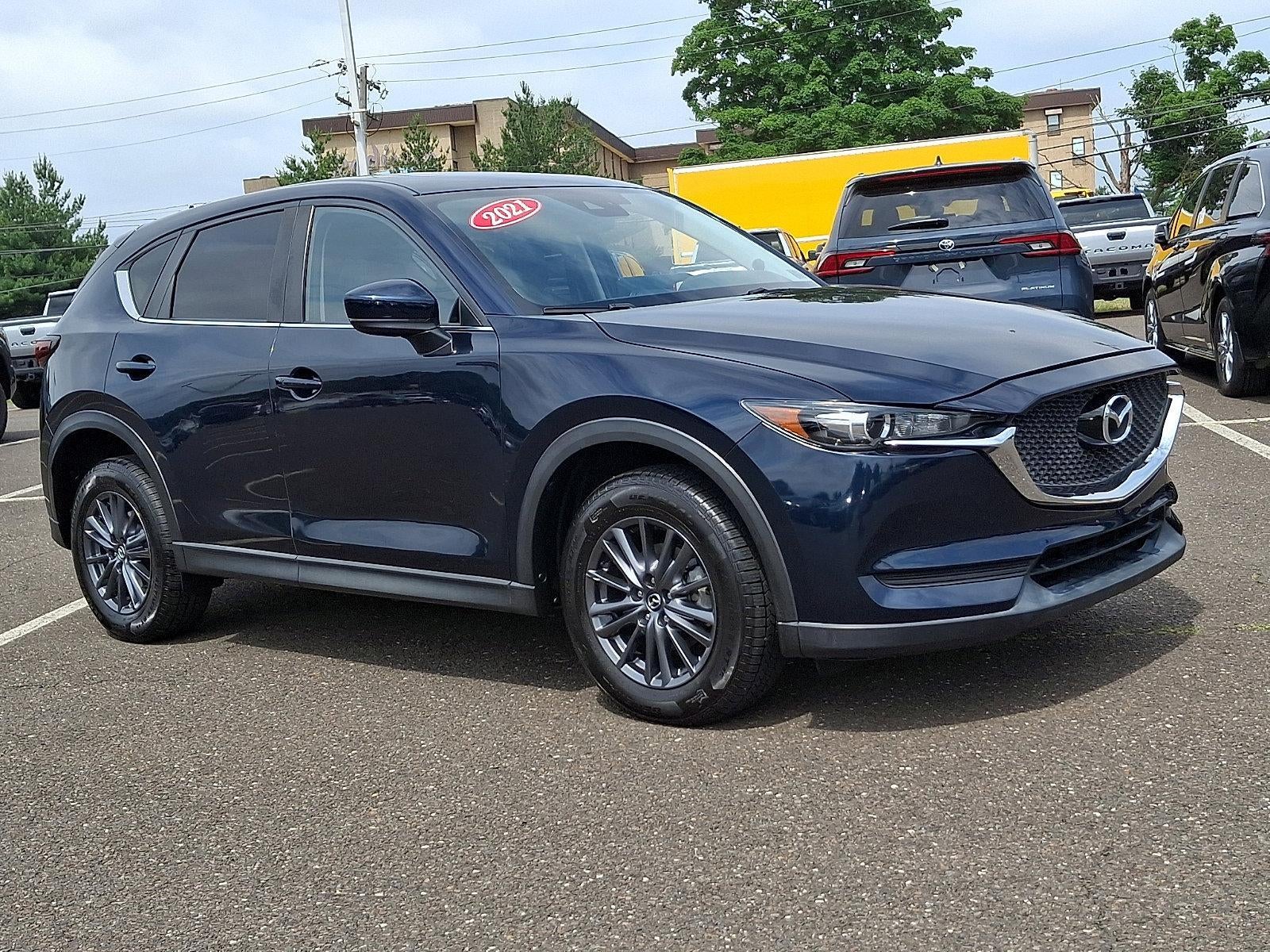 2021 Mazda Mazda CX-5 Touring AWD in Deep Crystal Blue Mica — front three-quarter view
