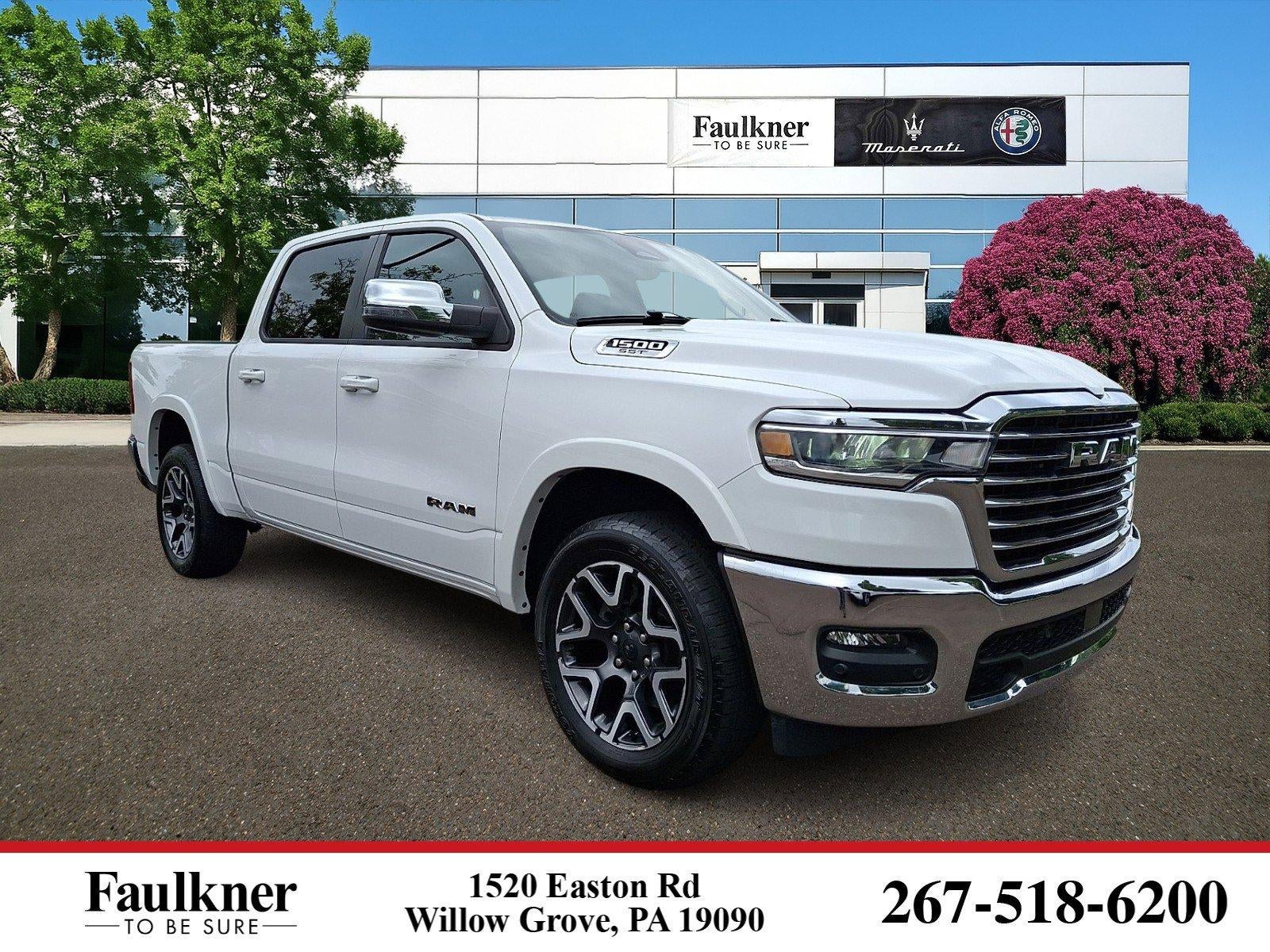 2025 RAM 1500 Laramie 4x4 Crew Cab 5'7" Box in Bright White Clearcoat — front three-quarter view