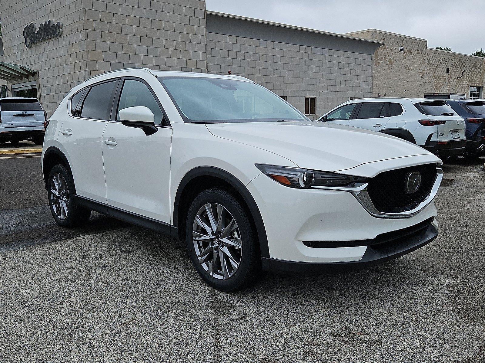 2021 Mazda Mazda CX-5 Grand Touring AWD in Snowflake White Pearl Mica — front three-quarter view